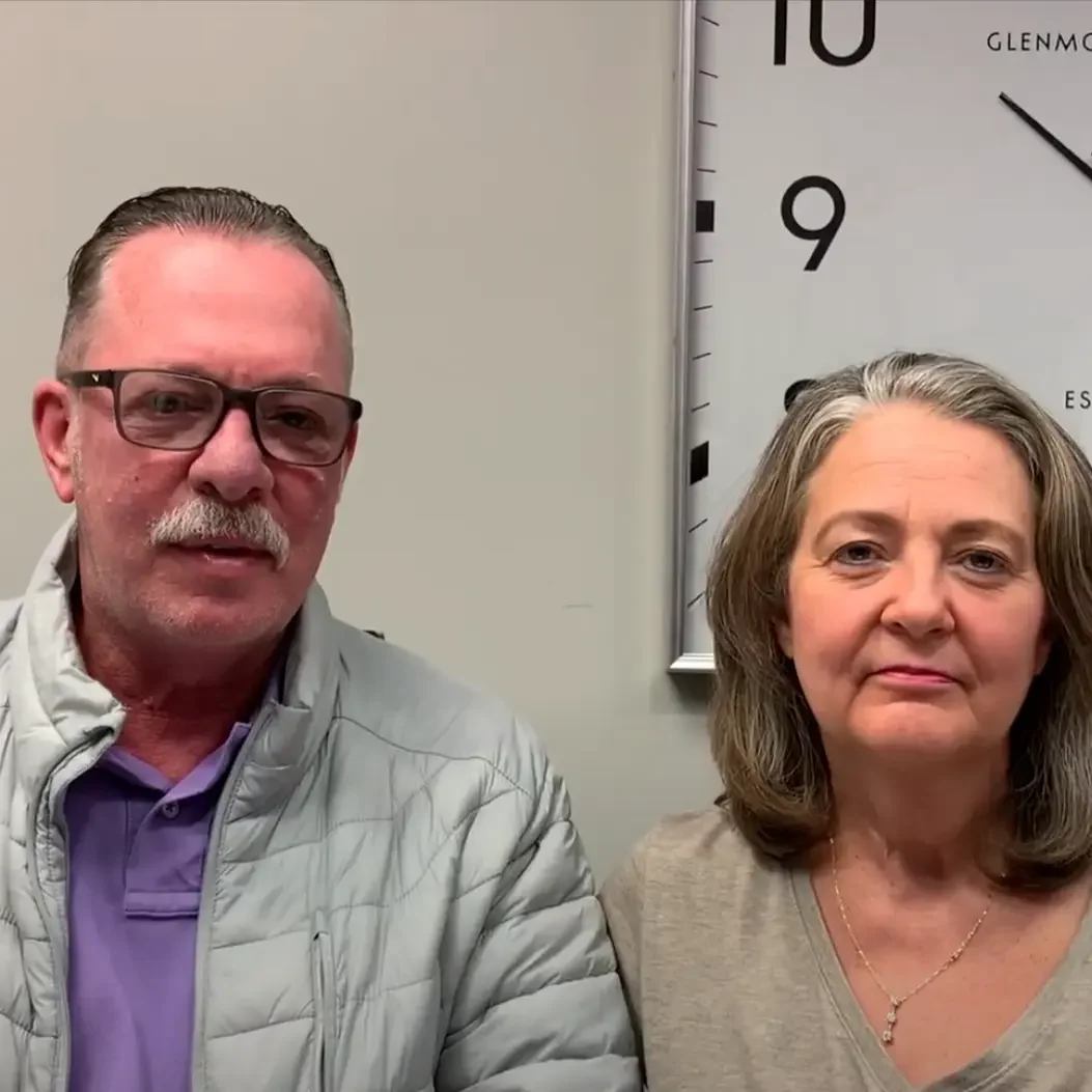 Kevin's Quick Home Sale Success: Columbus Cash Buyers Deliver Kevin, a satisfied home seller, with a woman in an office after successfully selling his Columbus house for cash