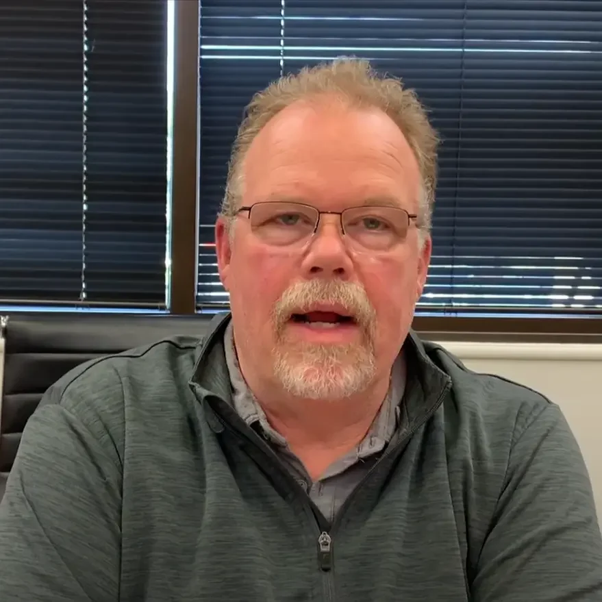 Dave's Story: A Smooth Columbus Home Sale with Cash Buyers Dave, a satisfied home seller, in an office after successfully selling his Columbus house for cash
