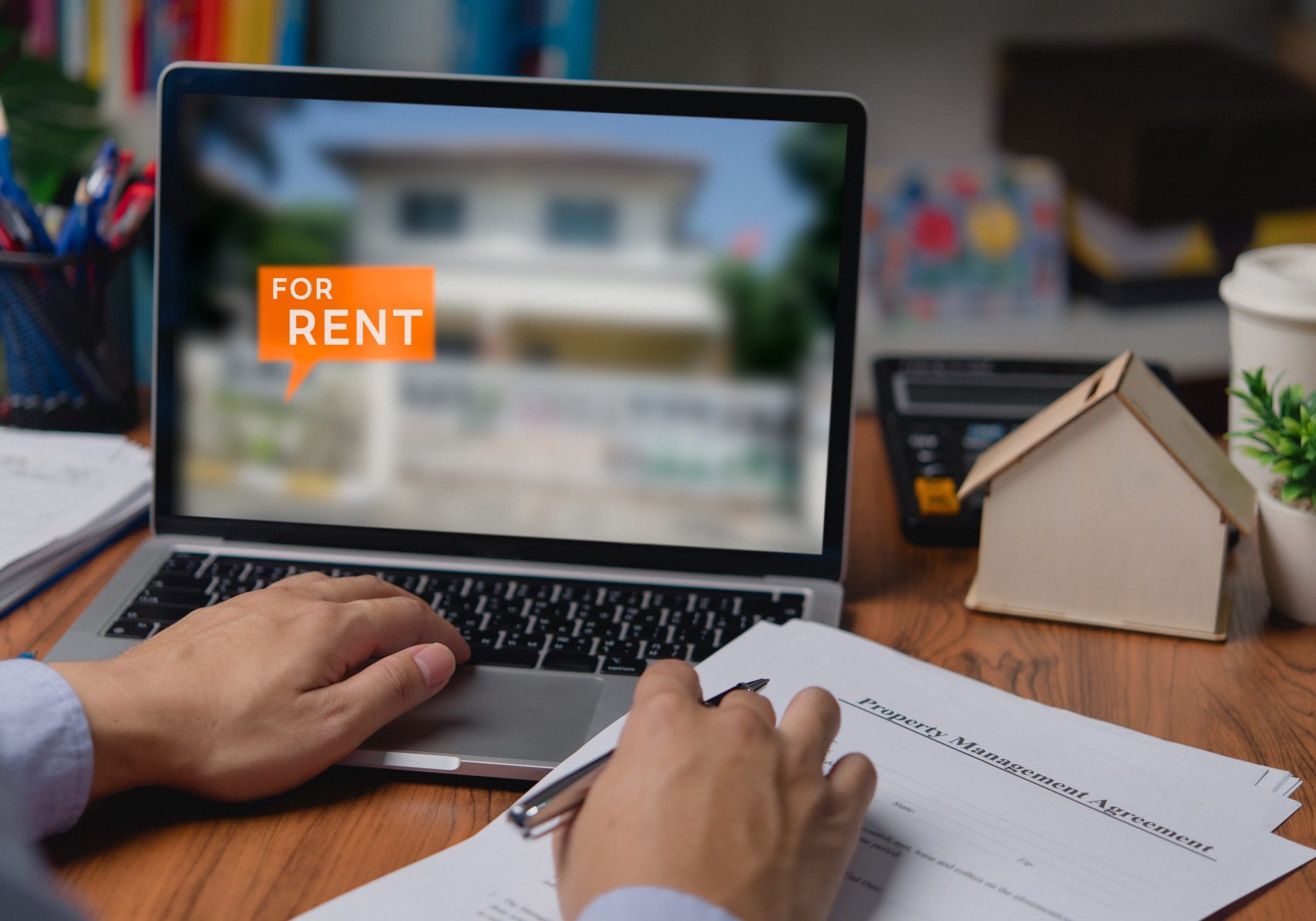 Man using laptop computer to search for real estate rental house or residential condo by internet Man using laptop computer to search for real estate rental house or residential condo by internet