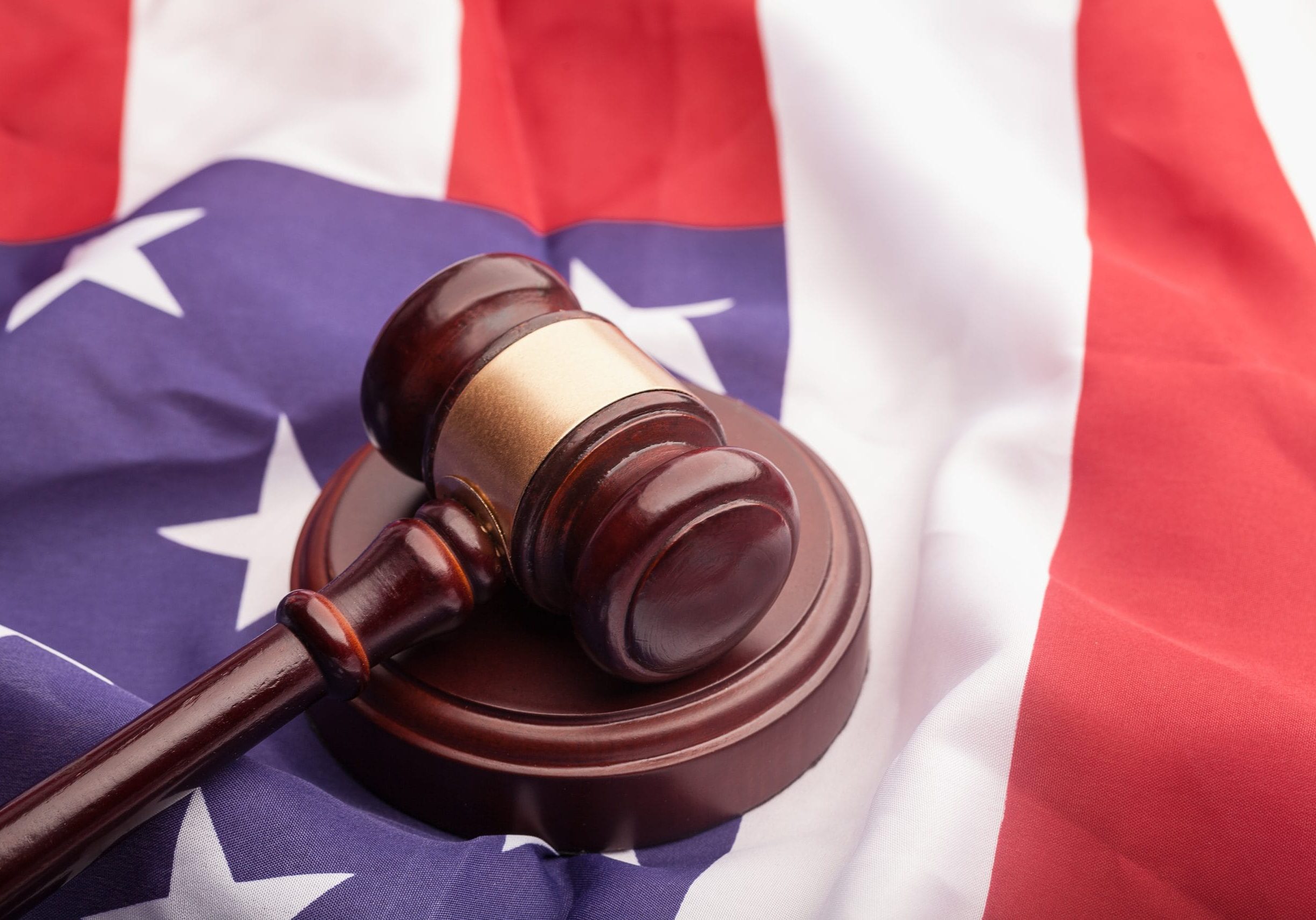Judges wooden gavel with EU flag in the background. Symbol for jurisdiction. Judges wooden gavel with EU flag in the background. Symbol for jurisdiction.