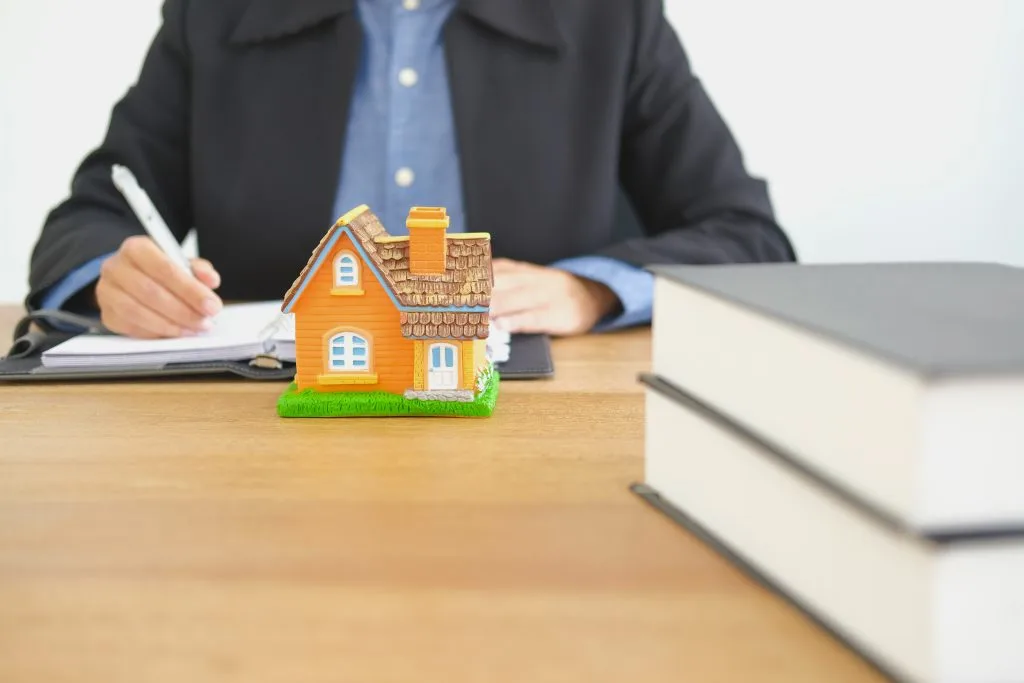 Man sitting at a table thinking about is he should sell his house to Opendoor