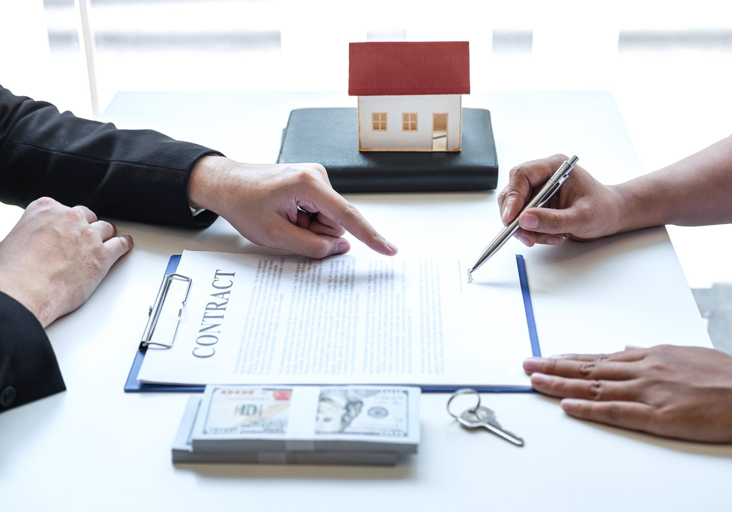 Estate agent broker pointing contract form to client signing agreement contract real estate with approved mortgage application form, buying or concerning mortgage loan offer for and house insurance.